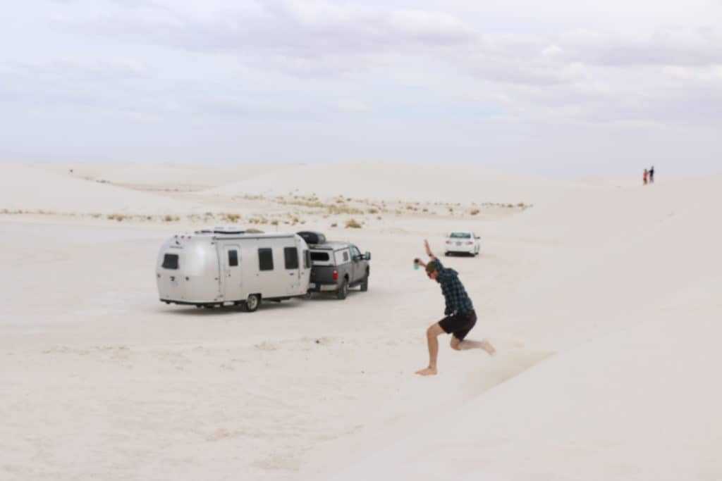 image of airstream dot on a sandy beach