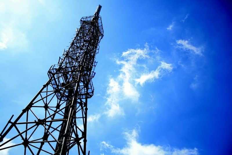 cell phone tower against a blue sky