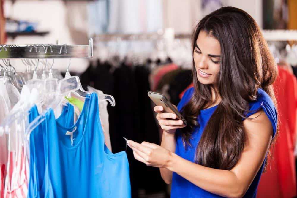 woman checking the price tag while shopping in store