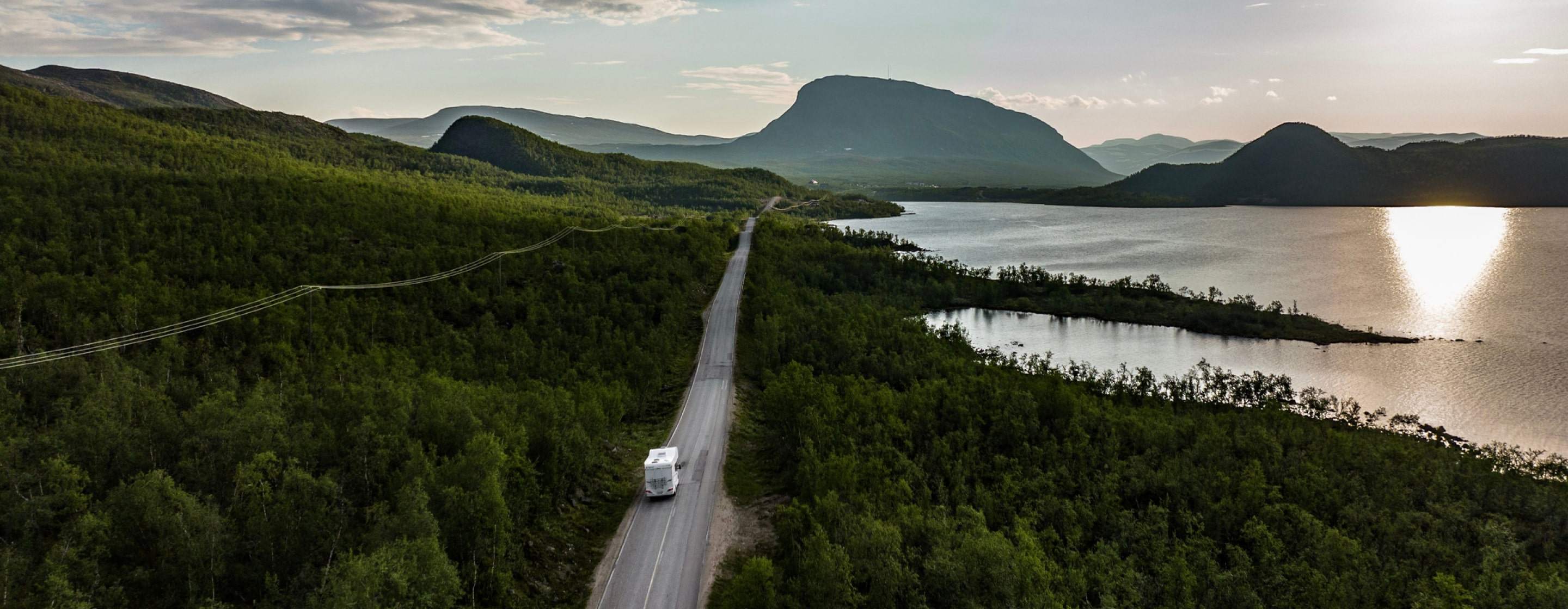 rv driving on lakeside road