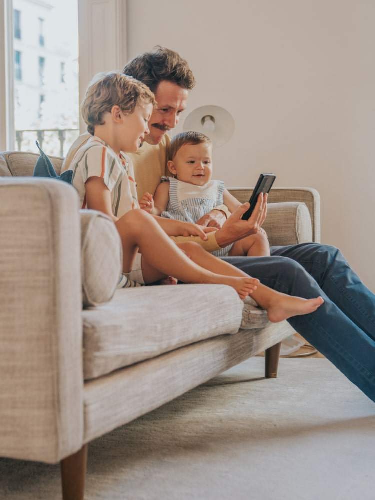 father and children on the couch