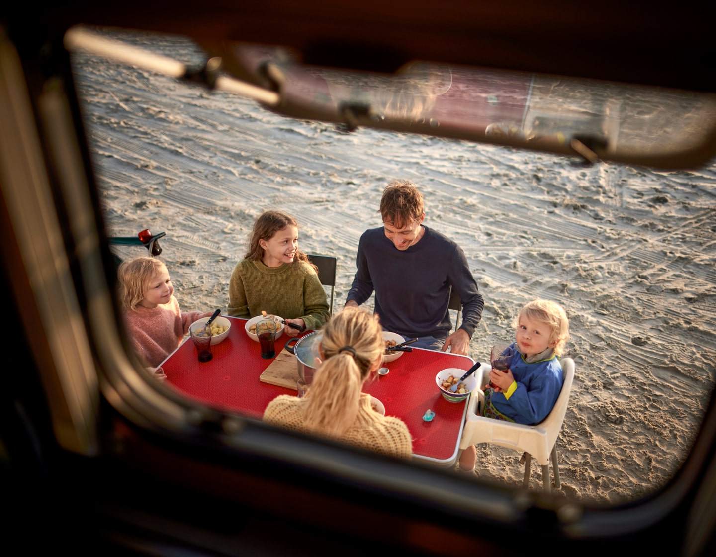 family eating outside rv