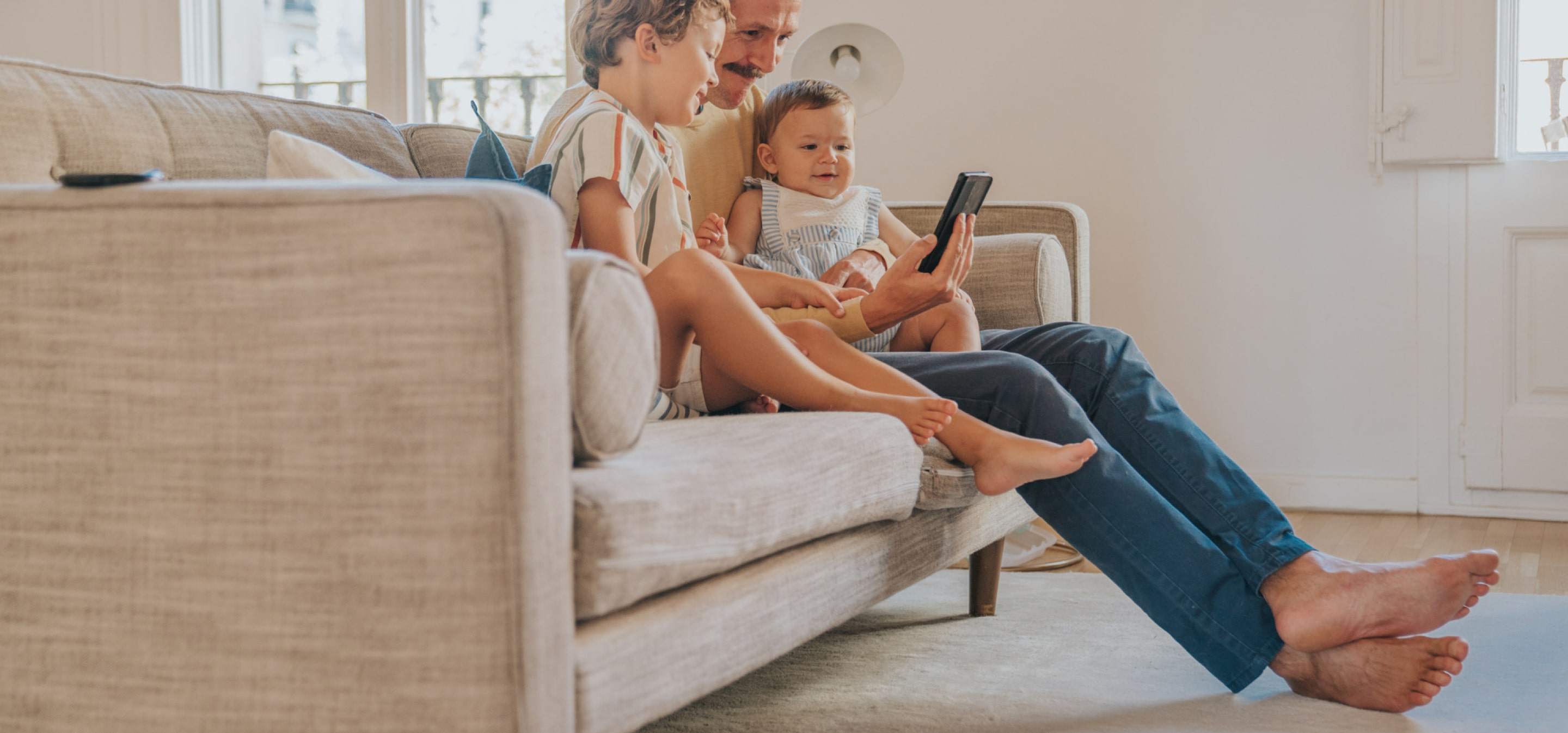 father and children on the couch