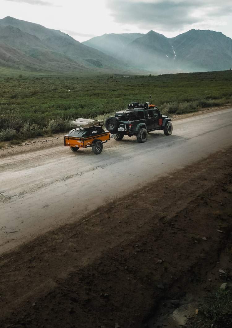 Overland vehicle driving through valley