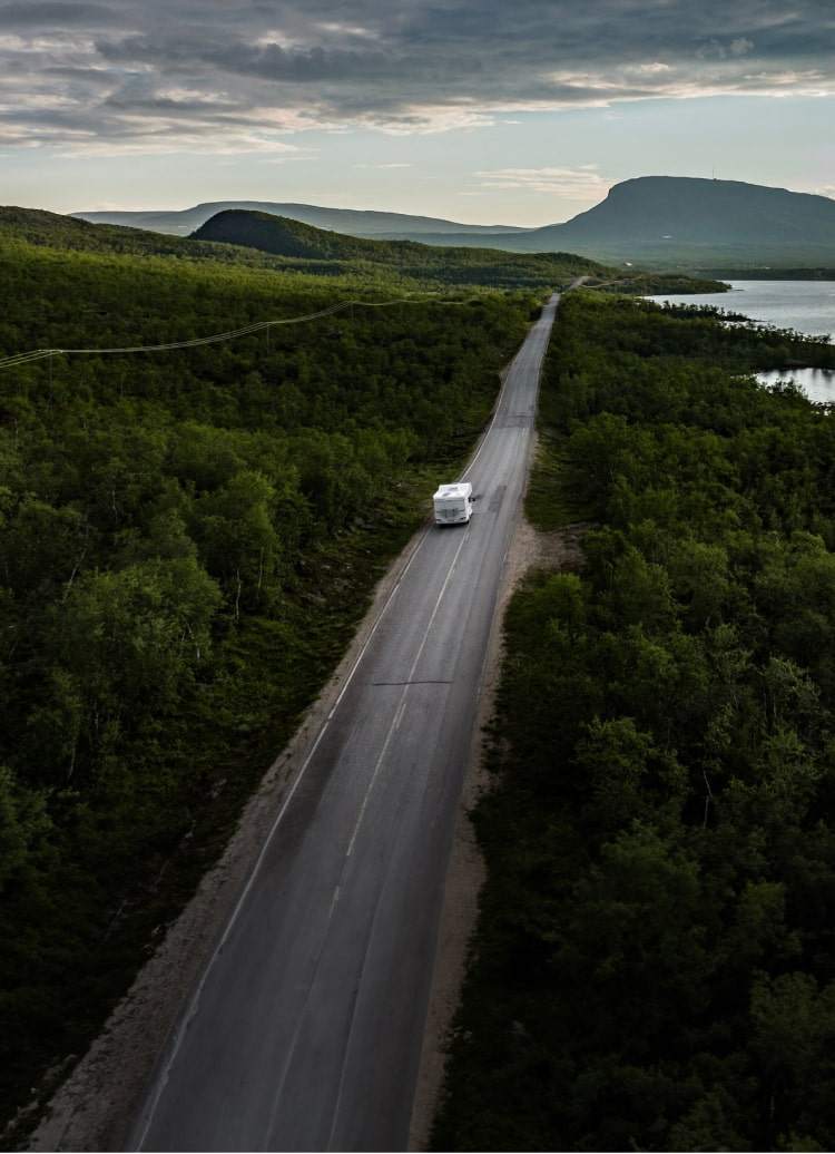 rv driving on lakeside road