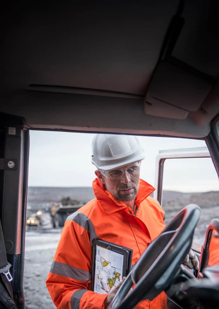 man looking into work vehicle