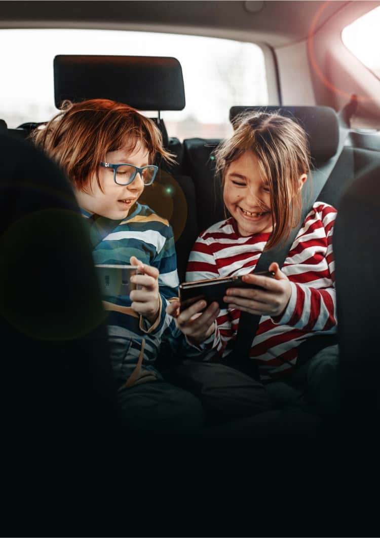 Kids having fun in back of car