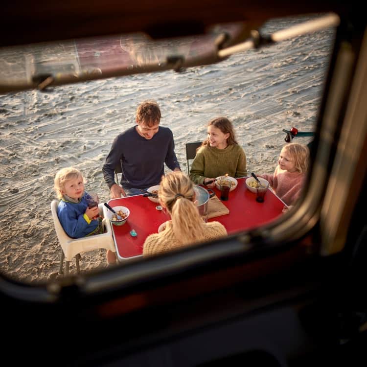 family eating outside rv