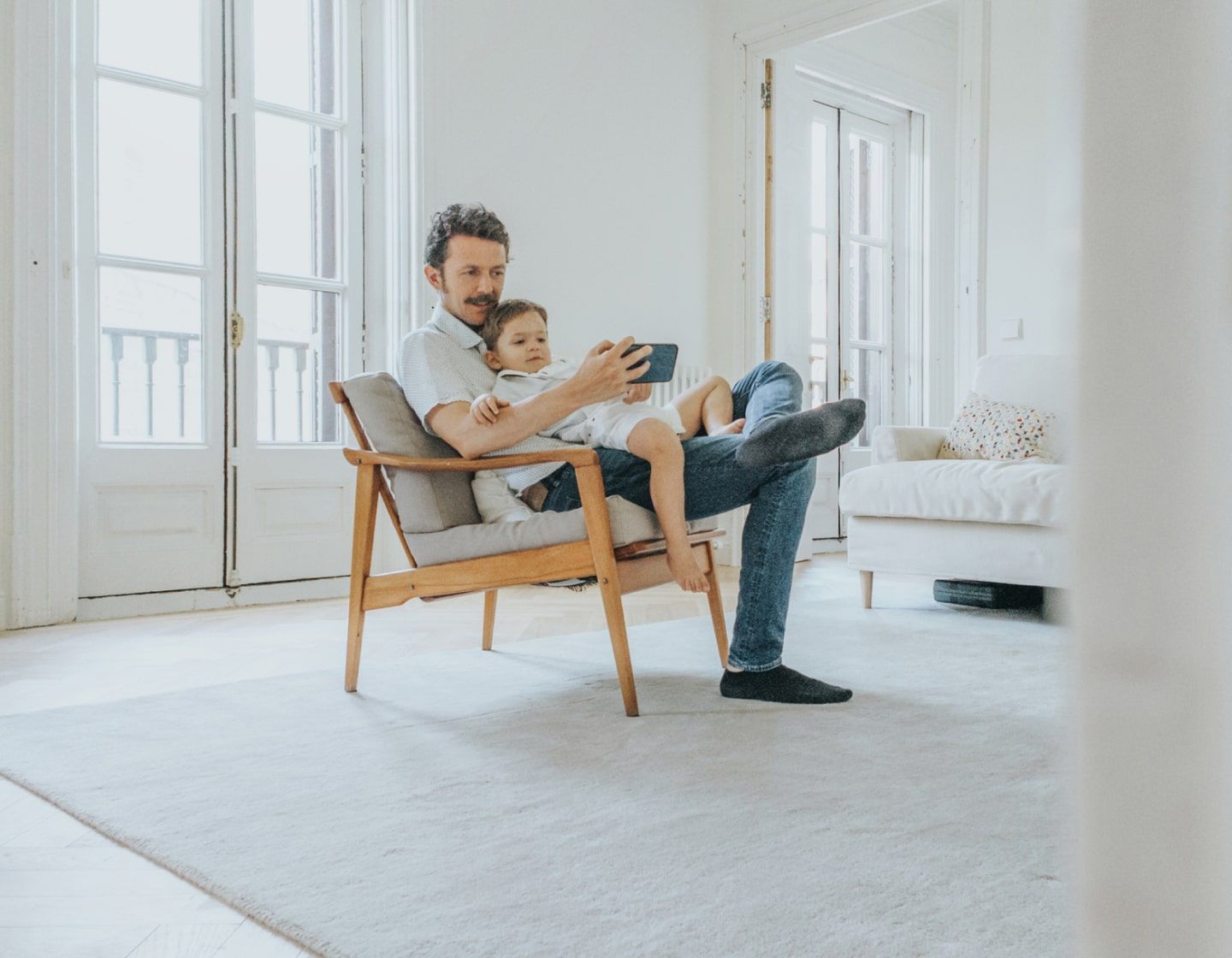 father and child using device