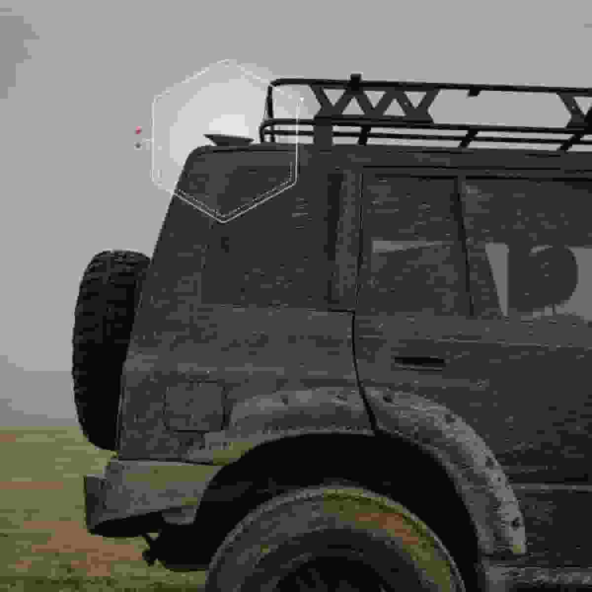 Rugged off-road vehicle with satellite antenna in dusty terrain.